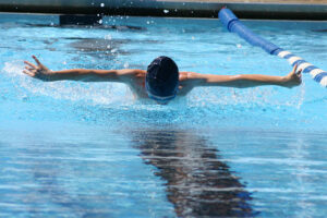 youth male swimming butterfly